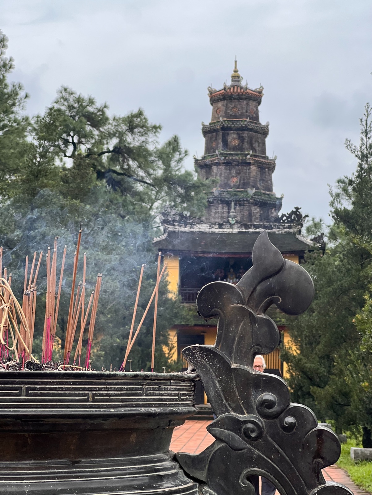 Incense smoke in front of the seven-storey Thiên Mụ pagoda in Huế